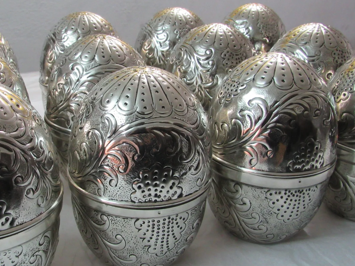 Decorative pierced metal pieces arranged as a finished batch