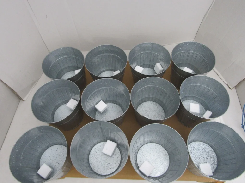 Galvanized planters arranged for batch quantity and finish review