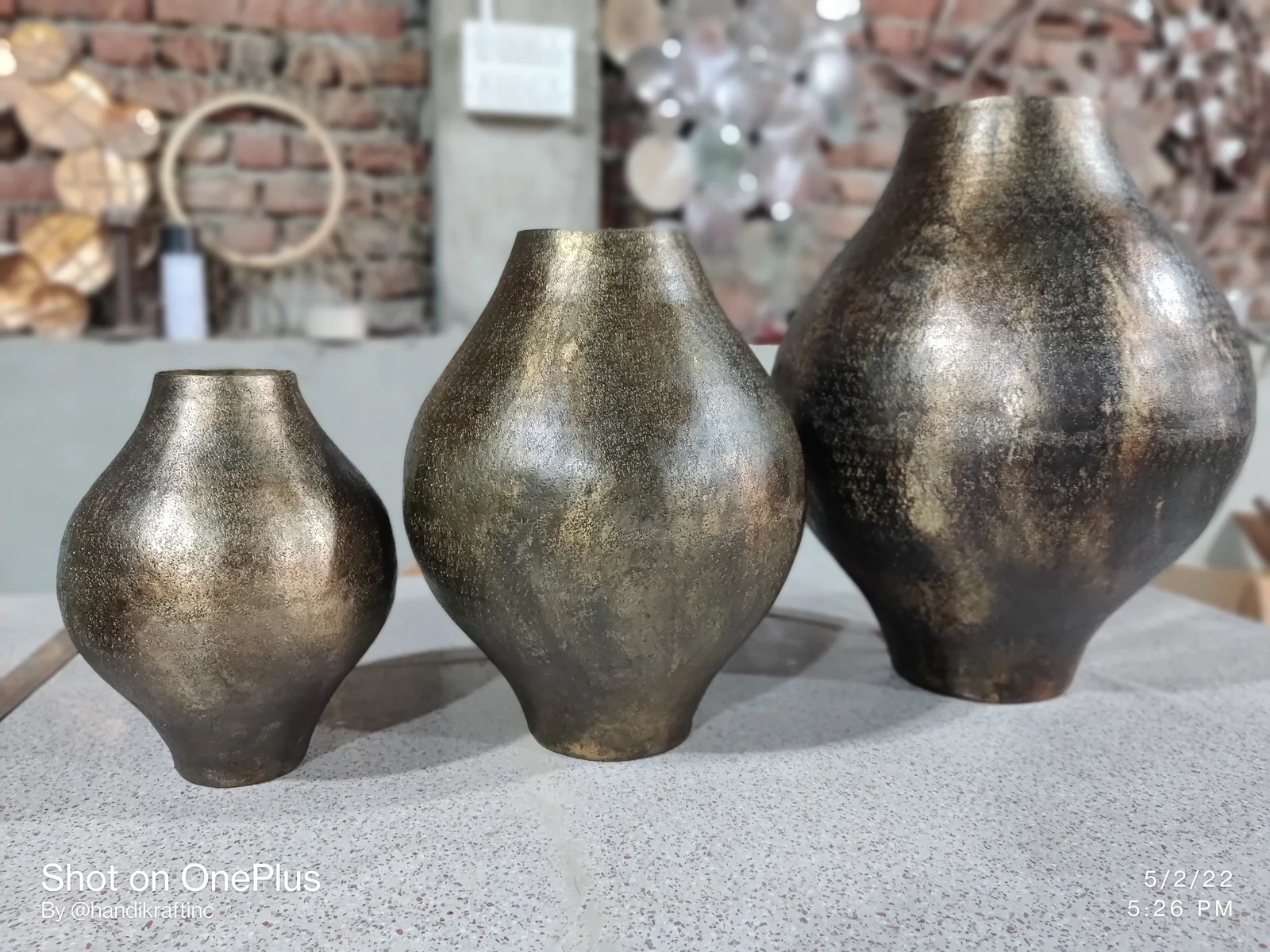 Set of hammered metal vases presented for finished-piece inspection